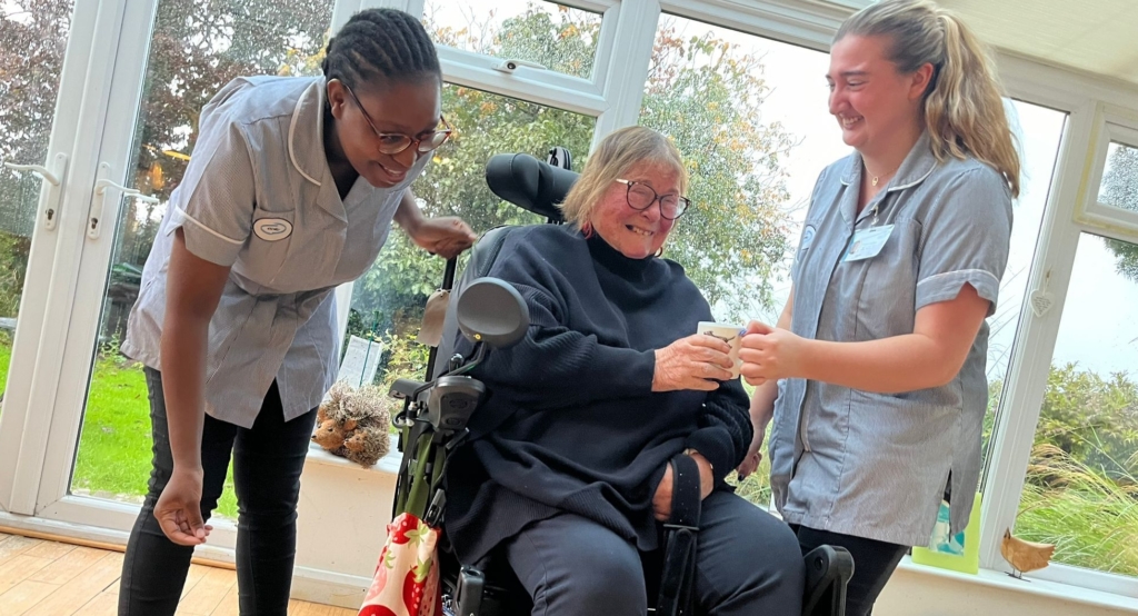 Compassionate carer supporting a patient in a wheelchair, illustrating dedicated Home Care for Multiple Sclerosis with personalised assistance and comfort.