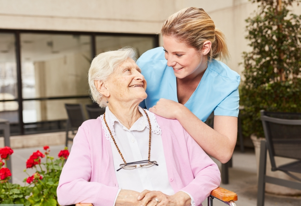 Elderly woman smiling with her carer during a companionship care for elderly session