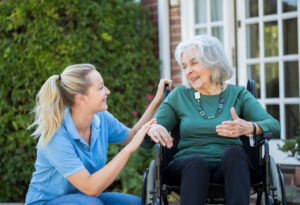 Carer offering compassionate support to an elderly woman in a home setting, representing high-quality private dementia care.